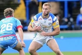 Rhinos' Jarrod O'Connor takes on Harvey Smith, of Wakefield, during Leeds' win on Boxing Day. Picture by Steve Riding.