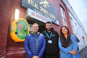 Tom Claisse, of Pro Elite Football, is pictured with Bilal Sports Centre director Kamran Khan and ward councillor Salma Arif with the newly-installed defibrillator. Picture: Steve Riding