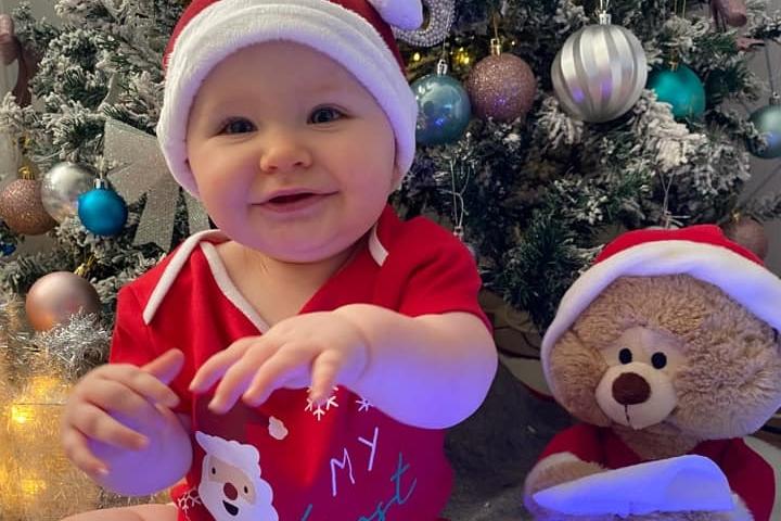 Nine month old Aayla in a cute Christmas outfit. Submitted by Megan Plunkett.