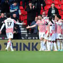 STOKE ON TRENT, ENGLAND - OCTOBER 21: Luke McNally (Hidden) of Stoke City celebrates with teammates after scoring their side's second goal during the Sky Bet Championship match between Stoke City and Sunderland at Bet365 Stadium on October 21, 2023 in Stoke on Trent, England. (Photo by Jess Hornby/Getty Images)