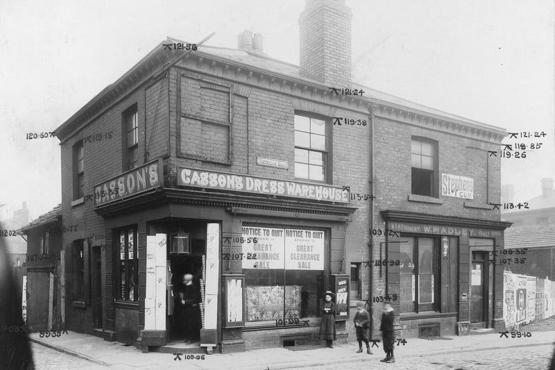 On the left is Chapel Walk, to the right no.55 Cusson and son drapers. Notices in the window advice of a sale before removal of business. Mounted to sides of window are display cabinets. Next, no.57 W. Radley stationary. Engineers elevation marks can be seen.