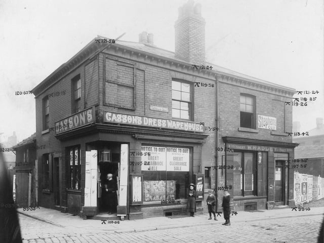 On the left is Chapel Walk, to the right no.55 Cusson and son drapers. Notices in the window advice of a sale before removal of business. Mounted to sides of window are display cabinets. Next, no.57 W. Radley stationary. Engineers elevation marks can be seen.