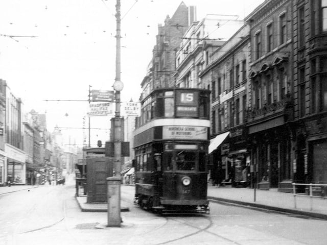 Tram No 147 travelling along Briggate on route 15 Whingate. Pictured in August 1954.