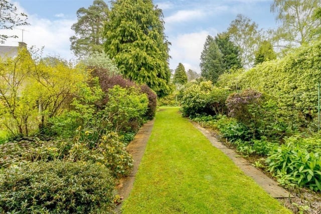 Plant and shrub-filled borders line path and walkways in the gardens.