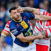 Jake Connor and St Helens' George Delaney give each other a hand during last week's huge clash which Leeds Rhinos won 24-16. Picture by Allan McKenzie/SWpix.com.