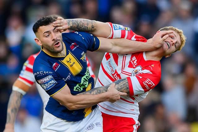Jake Connor and St Helens' George Delaney give each other a hand during last week's huge clash which Leeds Rhinos won 24-16. Picture by Allan McKenzie/SWpix.com.