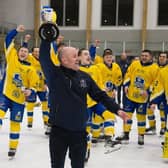 LEADING MAN: Head coach Ryan Aldridge holds the NIHL National league trophy aloft at Elland Road Ice Arena on Sunday night as his Leeds Knights' players watch on, having won the crown for the second year running. Picture: Jacob Lowe/Knights Media.