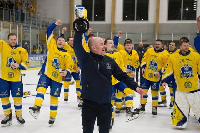 LEADING MAN: Head coach Ryan Aldridge holds the NIHL National league trophy aloft at Elland Road Ice Arena on Sunday night as his Leeds Knights' players watch on, having won the crown for the second year running. Picture: Jacob Lowe/Knights Media.