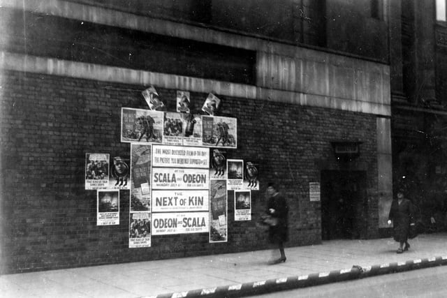 Marks and Spencer on Briggate in June 1942. With a bricked up front, the shop had been built but not opened to the public by 1940. It was requisitioned by the Ministry of Works. At this time there were public air-raid shelter facilities. The entrance can be seen on the right, posters advertising the film 'Next Of Kin' can be seen, it was showing at the Scala and Odeon Cinemas.