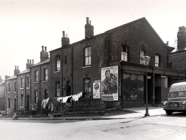 Looking across Camp Road to Glover Street in July 1958. On the wall is a recruiting post for the army 'Join the new Regular Army - A Real Man's Life'.