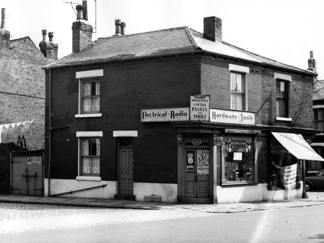 A hardware shop on the corner of Cambridge Road and Vaughan Street in August 1967. Business of Keith and son, selling electrical goods, radios, paint and tools. Signs on the door advertise coal for sale, and paraffin for heaters. To the right is S. Appleson shoe shop, then Oakfield Street is next.
