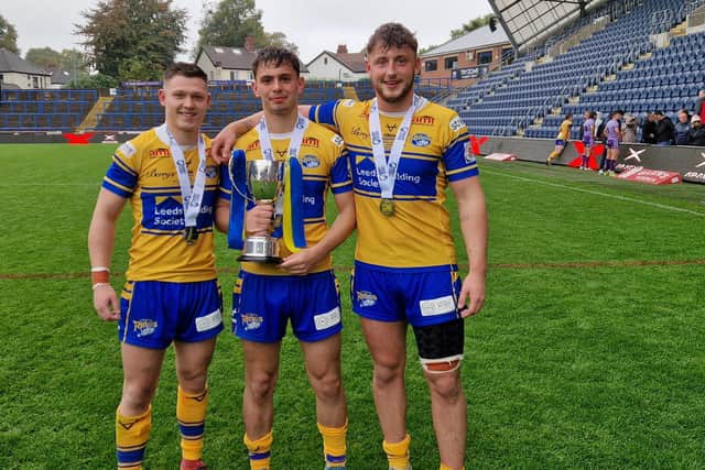 Noah Whittingham, right, with teammates Elliott Fox, left and Harry Smith following Rhinos' reserves Grand Final win against Warrington Wolves last September. Picture by Peter Smith.