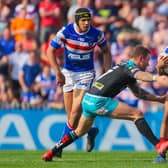 Mason Caton-Brown, of Wakefield Trinity, is tackled by Leeds Rhinos' Richie Myler during a Super League game at Belle Vue in April, 2019. Picture by Alex Whitehead/SWpix.com.