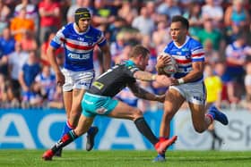 Mason Caton-Brown, of Wakefield Trinity, is tackled by Leeds Rhinos' Richie Myler during a Super League game at Belle Vue in April, 2019. Picture by Alex Whitehead/SWpix.com.