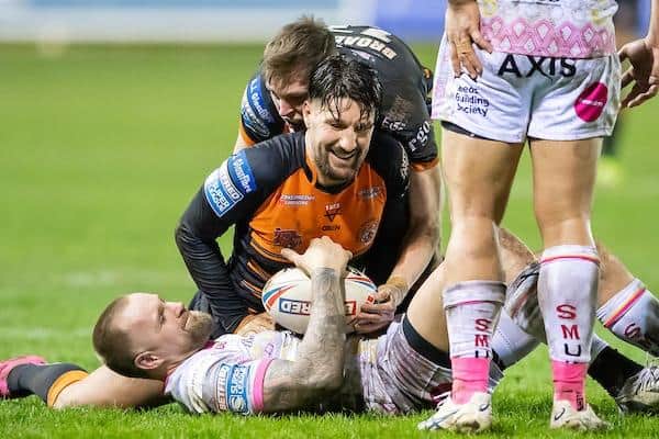 Gareth Widdop tackles Rhinos' Blake Austin. Picture by Allan McKenzie/SWpix.com.