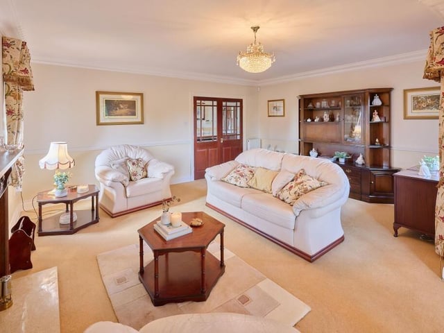 Double French doors lead from the hall into the lounge, which is attached to the rear-facing conservatory.