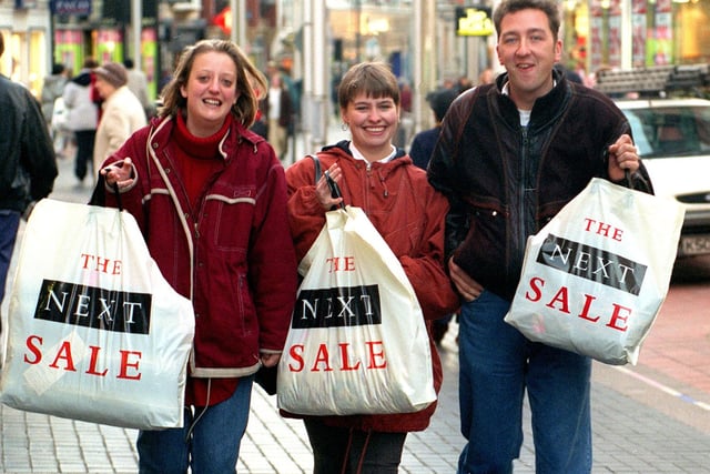Early-morning bargain hunters on Commercial Street in December 1995 are, from left, Joanne Paul, Gail Paul and Jonathan Henry.