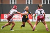 Leeds Rhinos' Lucy Murray is tackled by Georgia Wilson during a Women's Super League game at Wigan Warriors in May. Picture by Olly Hassell/SWpix.com.