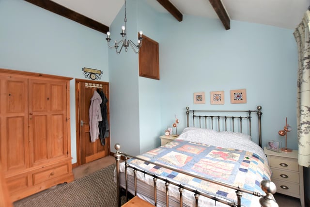 To the first floor is an impressive double bedroom enjoying high ceilings with exposed beams. There is a further double bedroom to the rear.