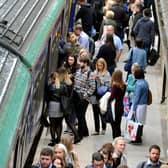 Commuters get on a train from Horsforth to Leeds Station. 