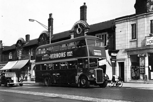 A bus on Roundhay Road near the Karnac Road junction in August 1959. The bus is the number 6, Roundhay Road, Briggate, Hunslet Road line heading for Briggate. An advertisement on the side of the bus reads, Double £75,000 + Surplus = Vernons, Fairer for All! On the far left is the Pearson & Benton newsagents with an awning stretched over the pavement. On the far right at number 250 is The Picture House. This 900 seat cinema opened on Monday, December 16, 1912, showing 'The Mine Owner', and closed Saturday, October 5, 1963 showing 'Last days of Pompeii'. On Friday, October 11, 1963 it went into use as a bingo hall and was eventually demolished in 1968. At the time of this photograph the cinema was showing Burt Lancaster in The Crimson Pirate (1952).