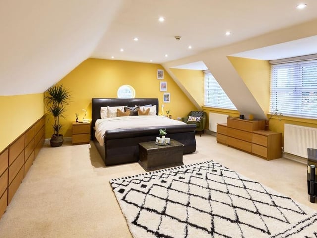 The master bedroom has a unique round porthole window and an en suite that has a large walk-in rainfall shower.