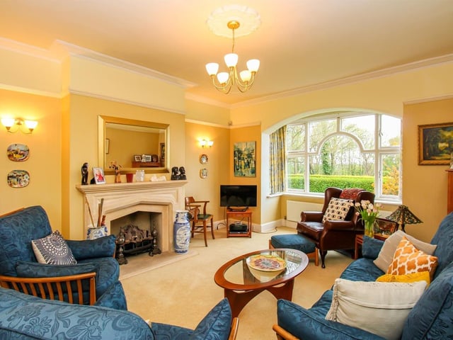 The lounge has a timber framed single pane window to the rear and a timber framed single pane box window to the side. There is also a central heating radiator, coving to the ceiling, a picture rail, and a gas fireplace with a stone hearth.