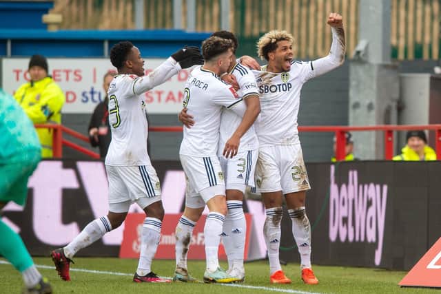 GOING THROUGH: Leeds United celebrate Junior Firpo's strike at Accrington. Picture by Bruce Rollinson