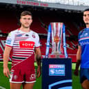 Wakefield Trinity forward Caleb Hamlin-Uele and Brad O'Neill, of Wigan Warriors, with the Betfred Super League trophy at Old Trafford. Picture by Allan McKenzie/SWpix.com.