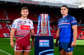 Wakefield Trinity forward Caleb Hamlin-Uele and Brad O'Neill, of Wigan Warriors, with the Betfred Super League trophy at Old Trafford. Picture by Allan McKenzie/SWpix.com.