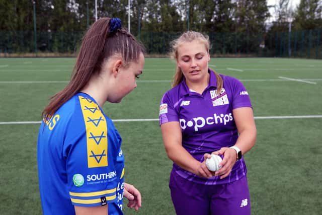 Rhinos' Ella Johnson gets some tips from Northern Superchargers' Bess Heath.
