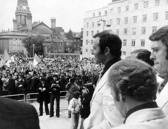 Leeds United manager Jimmy Armfield leads out the team to greet supporters on the steps of Leeds Civic Hall arfter the team arrived back from Paris in May 1975.