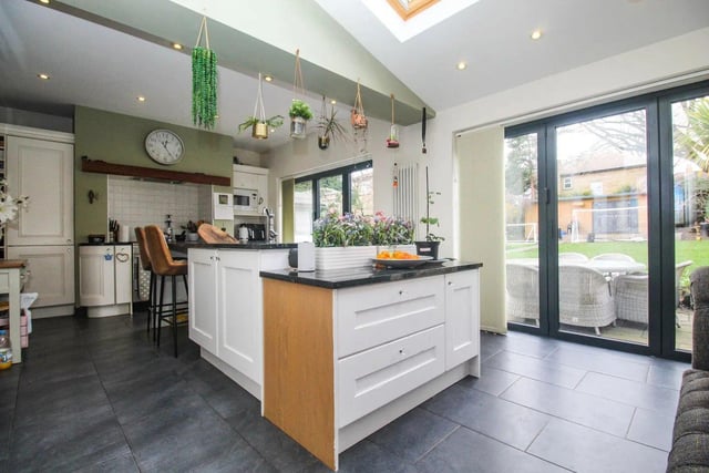 Off the dining space is a large, light and modern family kitchen. The wonderful island sits at the heart of the space and a built-in large gas cooker within a chimney feature creates a great focal point.