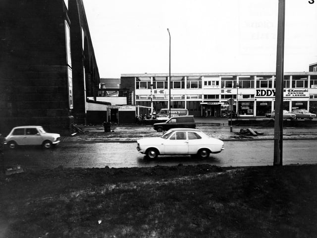 Eddy's Motorcycles on Kirkstall Road which described itself as the 'Kawasaki Centre of Leeds'. The arches of the railway viaduct can be seen on the left. Pictured in December 1980.