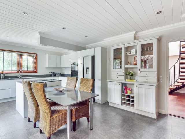 Light floods through to this fitted dining kitchen with a central island.