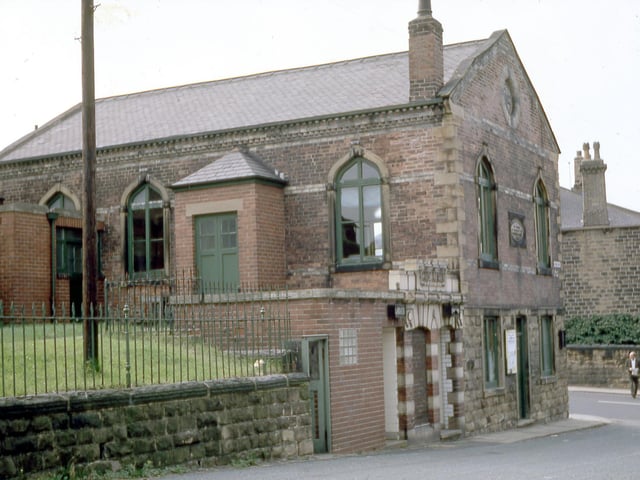 Churwell Town Vestry which stands at the junction with Elland Road and Victoria Street, looking from Victoria Street in August 1968. A man can be seen crossing Elland Road and part of Churwell post office in Clarendon Terrace is visible behind him. The Town Vestry was built in 1863 on the site of the old village school and later became known as the Town Hall. It was a place where the people of Churwell met to discuss and organise the village affairs. In 1901 it became the Sunday School of All Saints Church. Since the 1970s it has been run as Churwell Community Centre.
