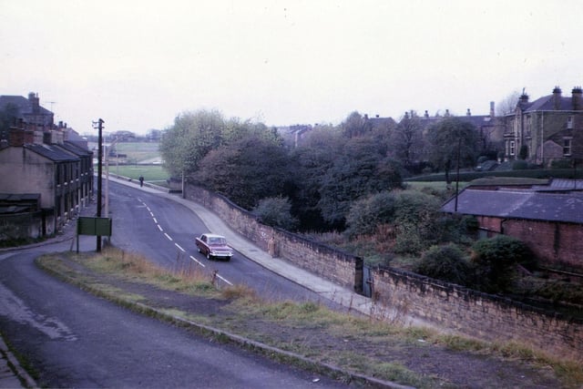 Brunswick Street looking towards Morley Hole, seen from Dawson Hill. The building in the foreground on the right belong to Victoria Mills, while the large detatched house behind is Vivian House. To the left of this are the backs of houses which face onto Victoria Road. On the left of the picture are terraced houses which were soon to be demolished. Pictured in October 1963.
