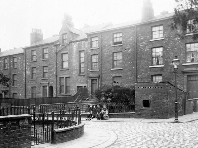 Located off south Carnaby Street, this is the West side. Terrace houses with varying features and of different layout and size, with gardens. A group of children are posing for the camera in period dress. Pictured in August 1913.