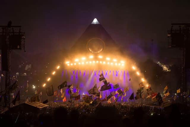 Revellers watch as The Killers perform on the Pyramid Stage at Glastonbury Festival 2019 (Photo: OLI SCARFF/AFP via Getty Images)