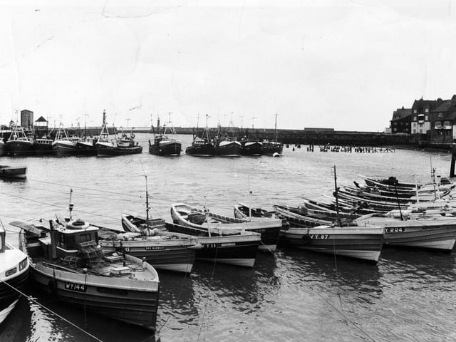 Fishing vessels form a strong line of defence at the entrance to Whitby Harbour in March 1975.