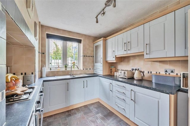 The kitchen is fitted with shaker style units, built-in oven and gas hob, washing machine, fridge and freezer, side access door and a large pantry cupboard.