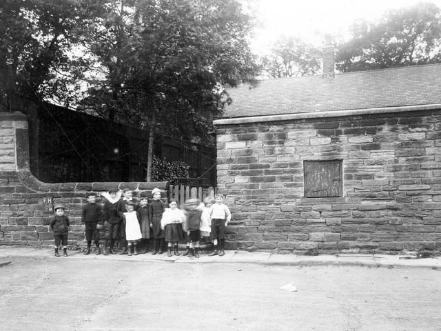 Children stand in front of property adjoining the tower on Woodhouse Cliff in 1913.