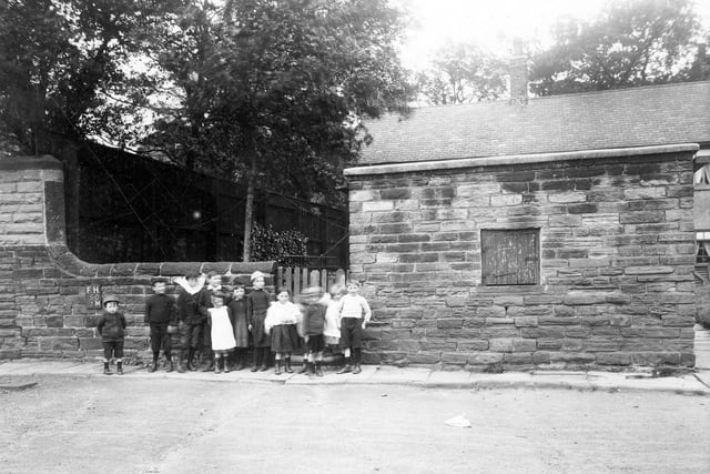 Children stand in front of property adjoining the tower on Woodhouse Cliff in 1913.