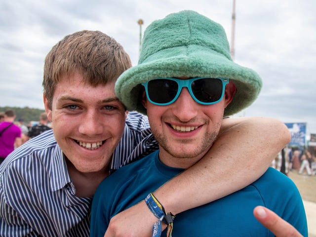 A fan sports a fluffy bucket hat as they pose for a picture on day one of Leeds Festival