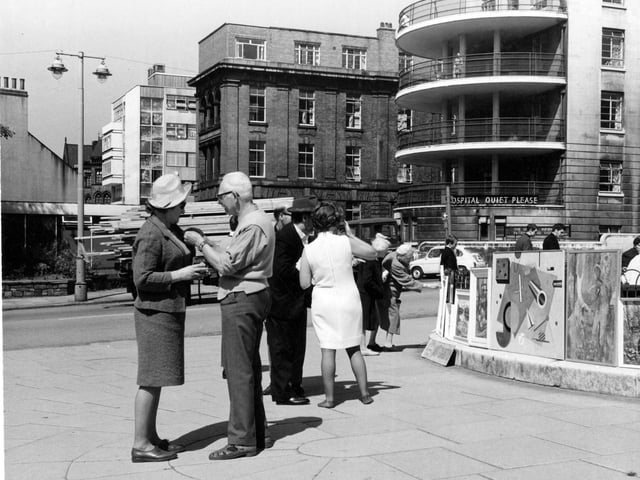 People enjoy an exhibition on Calverley Street in July 1967. Leeds General Infirmary can be seen in the background.