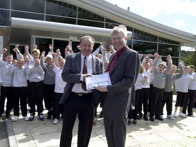John Ellis, governor at Cockburn High School in Beeston receives his award from Chris Edwards of Education Leeds for being a school governor for 15 years. Pictured in September 2001.