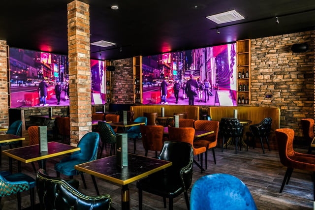There are stone walls, four large TV screens and a wooden theme throughout.