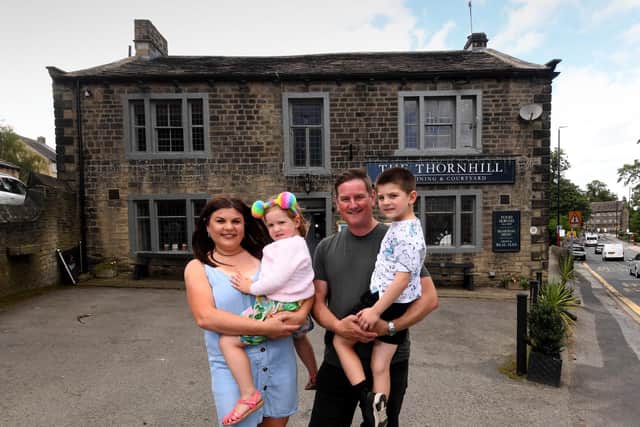 The Thornhill pub in Calverley, Leeds, is celebrating its 350th birthday this weekend. Pictured are owners Jamie and Sally Hanson pictured with their children, Thomas and Holly. (Photo by Simon Hulme/National World)