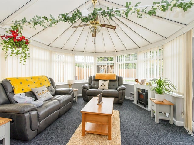 The conservatory has a ceiling fan and UPVC double glazed French doors leading out to the rear garden.