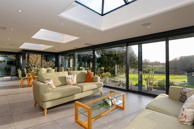 A spacious garden room has extensive views of lawns and countryside.